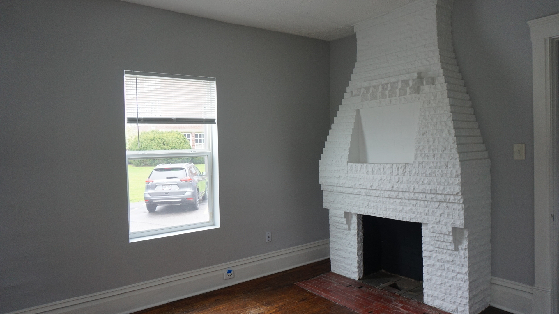 Living Room, entrance point with brick fireplace - 129 N Main St