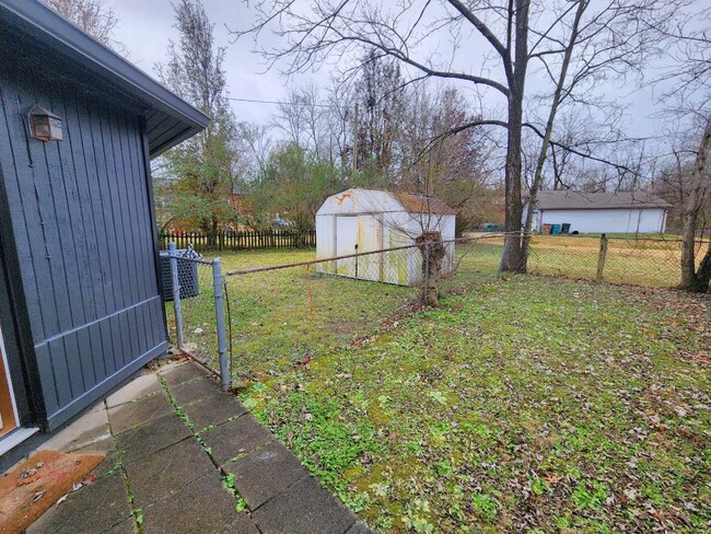 Fenced in back patio with additional storage if needed - 304 Myrick Dr