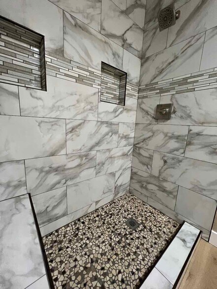 New custom tile walk-in shower with bench and two boxes for shower supplies - 3183 Wayside Plz