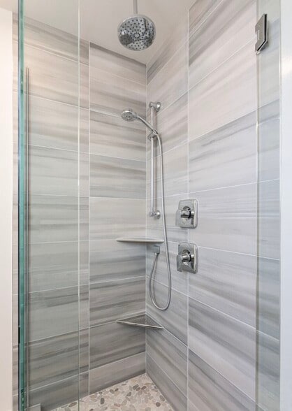 Walk-in shower with a clean, enclosed layout and functional space. - 2921A Franklin Ave E