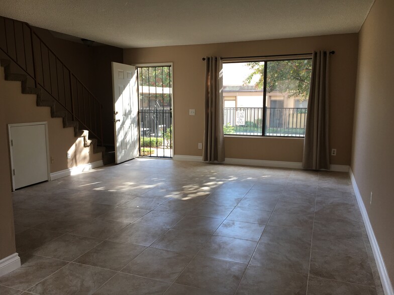 Living room with new tile. Townhouse has been completely repainted. - 9831 Sepulveda Blvd