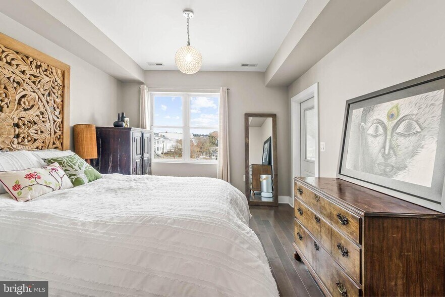 Primary bedroom includes a walk-in closet, a full primary bath in-suite, east-facing windows - 3821 14th St NW