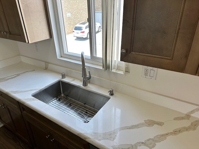 Bright countertops, modern cabinetry, and deep sink. - 5510 Adelaide Ave