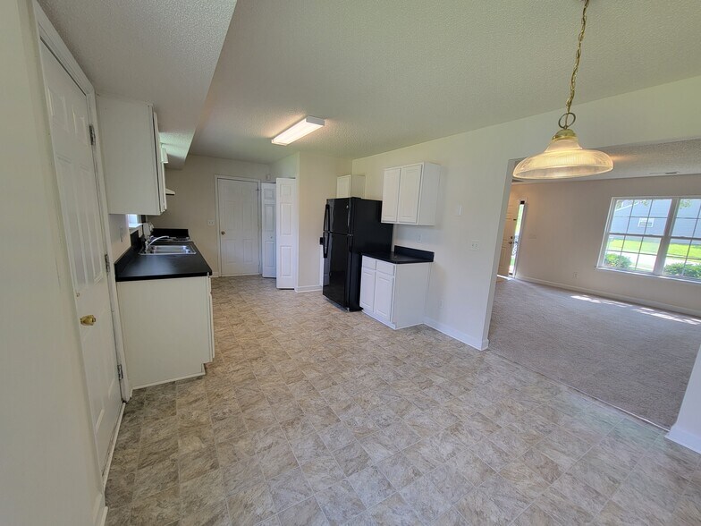 Large dining space that looks into the kitchen and living room. This can also double as an office. - 6903 Seney Dr