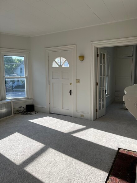 Living room featuring brand new carpet bay window and decorative fireplace. - 401 North St