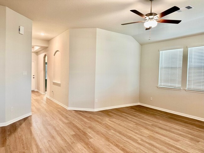The large living room has a ceiling fan and plenty of natural light! - 507 Turtle Dove Dr