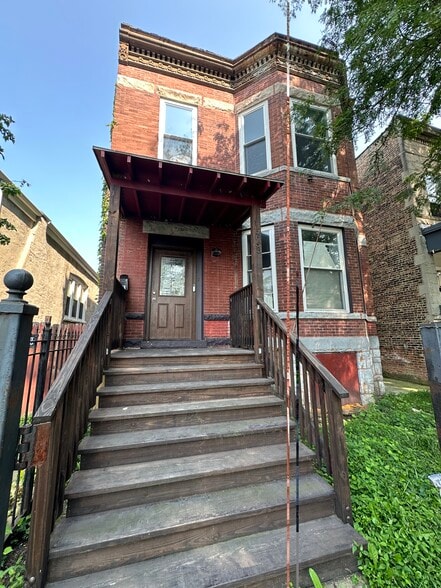 Front stairway leading up to the private entrance of this fully renovated first-floor unit - 5653 S May St