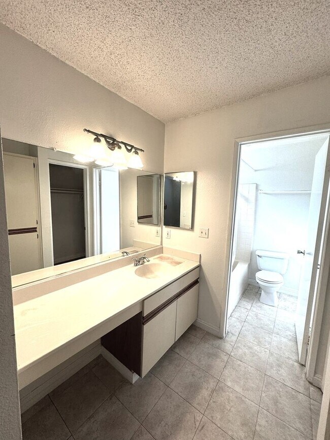 Building Photo - 2 Bedroom, 2 Bath Upstairs Condo with Private Balcony & 2-Car Garage, Gated Community, Water/Tras...