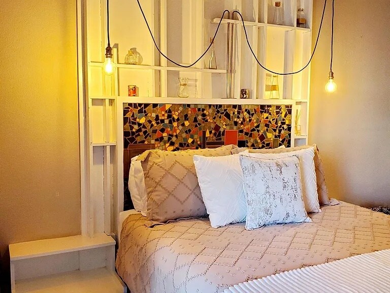 Primary bedroom with handcrafted mosaic headboard - 140 Uwapo Rd