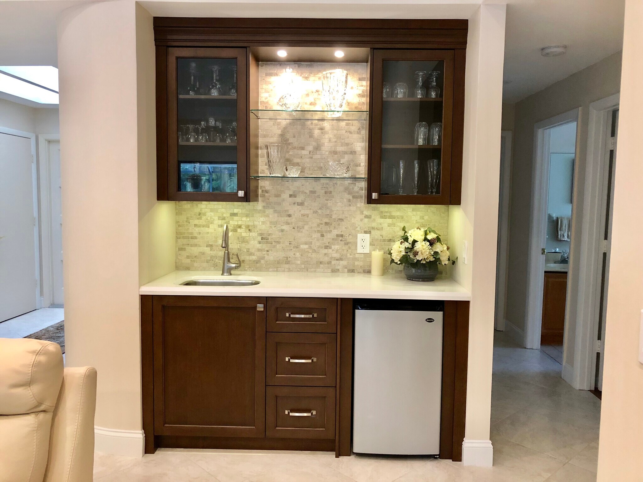 Lighted display cabinets with under-cabinet lighting accented by granite and quartzite. - 2662 NW 42nd St