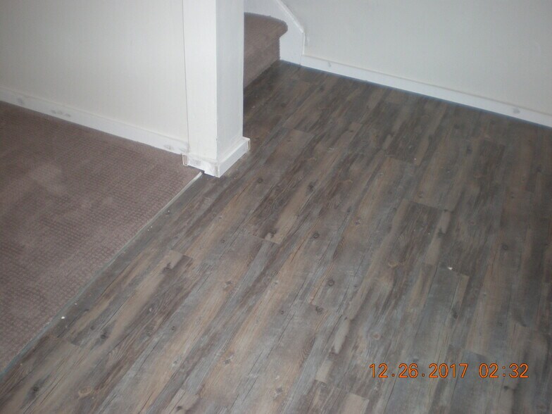 New easy care vinyl flooring downstairs in hallway. - 1160 Clinton St