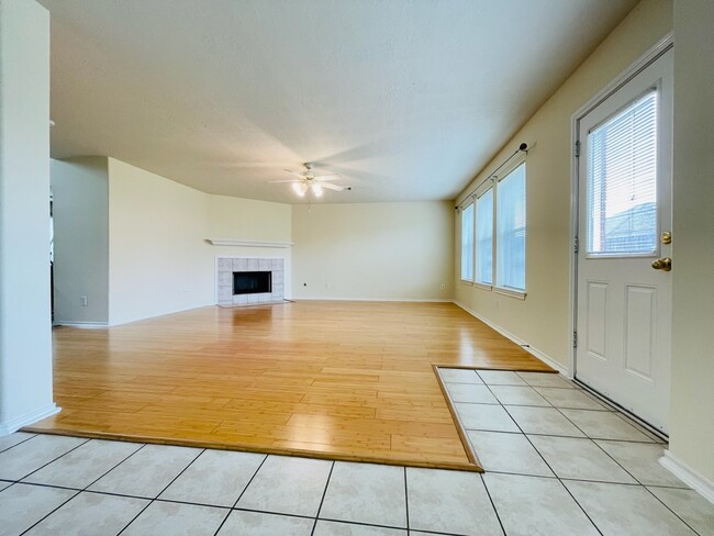 Living room with laminate flooring, fire - open concept with plenty of natural light, - 18911 Piney Bend Ct