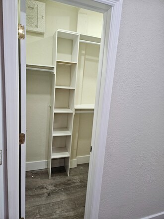 Walk-in closet with additional shelving and storage area - 2385 SW 25th St