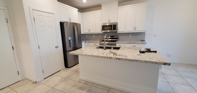 Building Photo - Beautiful townhome features a bright, open-concept layout