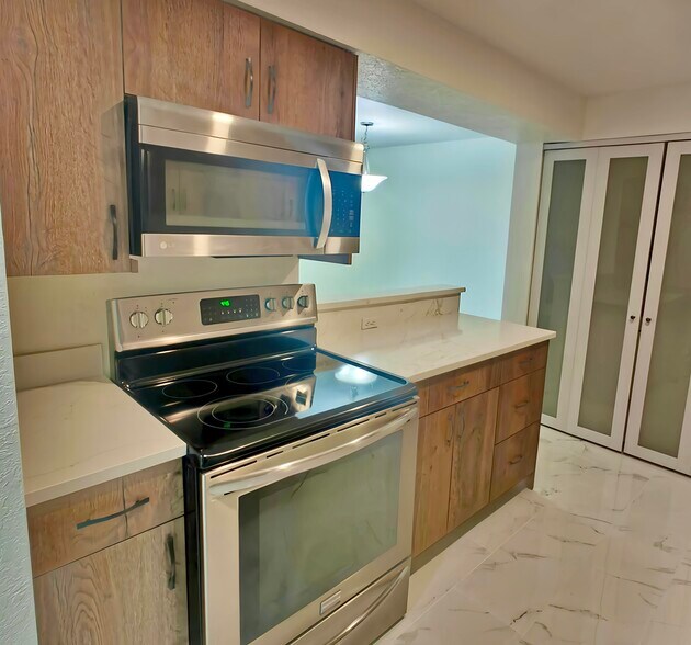 Kitchen with all new flooring, cabinets, and countertops! Laundry Closet in back. - 9494 Redmond Woodinville Rd NE