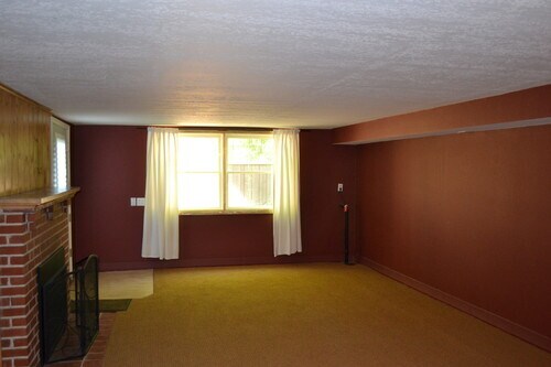 Downstairs family room includes gas fireplace. - 9121 SW 35th Ave