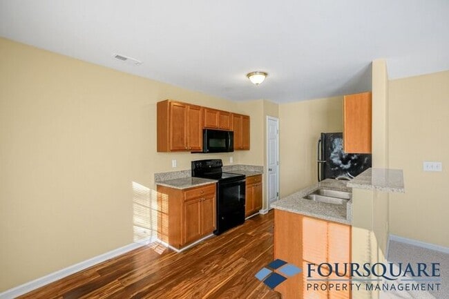 Building Photo - Charming 3-Bedroom Townhome with First-Floor Suite & Off-Street Parking – Near Capital Blvd & I-440