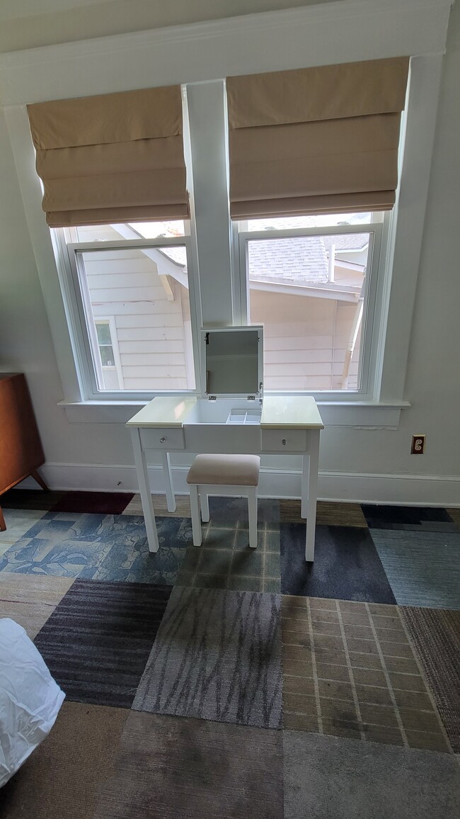 Vanity in bedroom. Mirror folds down to create a desk area - 1755 Marietta Rd NW