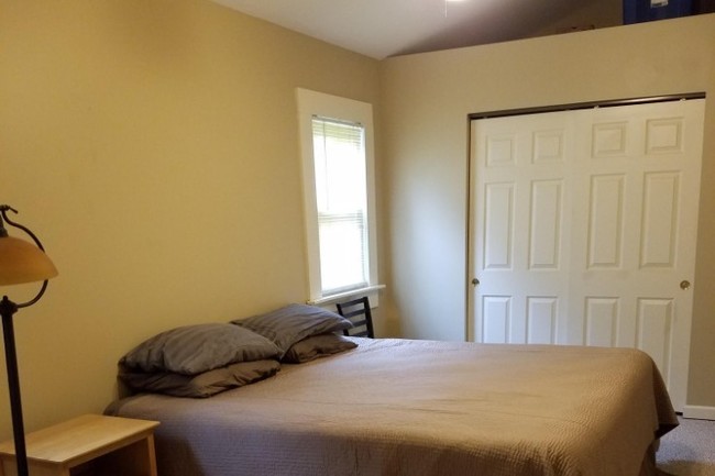 Bedroom 1, vaulted ceiling, spacious closets - 103 W 12th St