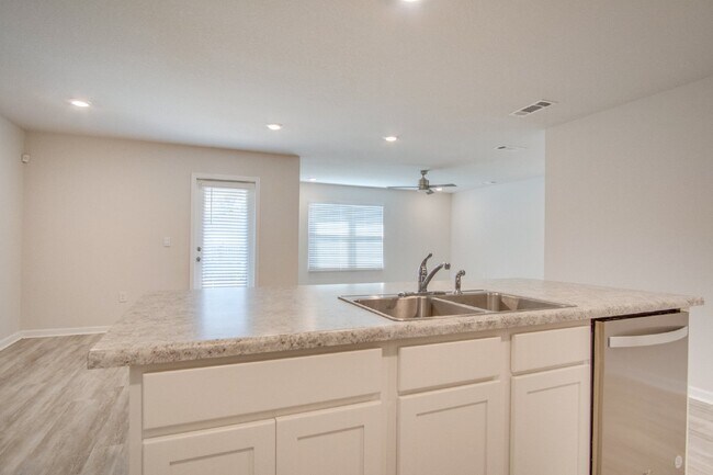 Building Photo - 4-Bed, 2-Bath Home in Woodlands Subdivision with Solar, Open-Concept Living, Modern Kitchen, Fenc...