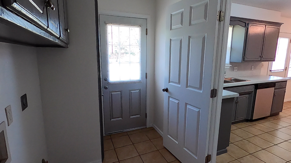 View of utility room with second door to backyard - 415 W Guthrie St