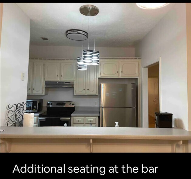 Kitchen with bar seating - 161 Shelby Dr