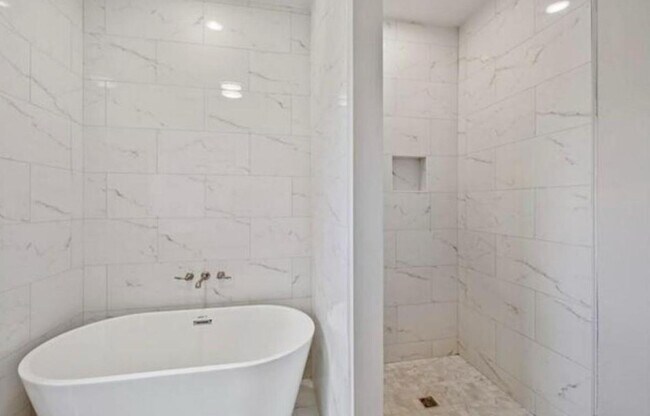 Primary Bath with Soaking tub, Double Vanities, and marble tile - 3137 Pauger St