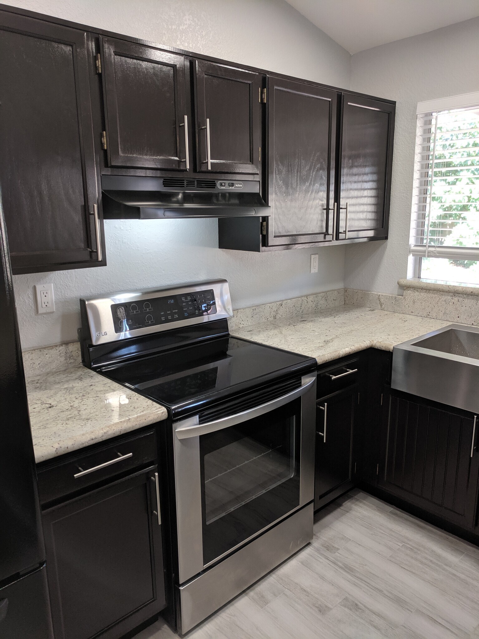 Less than 2 year old LG stainless and black stove with Hood. North Wall - 14101 N 78th Dr