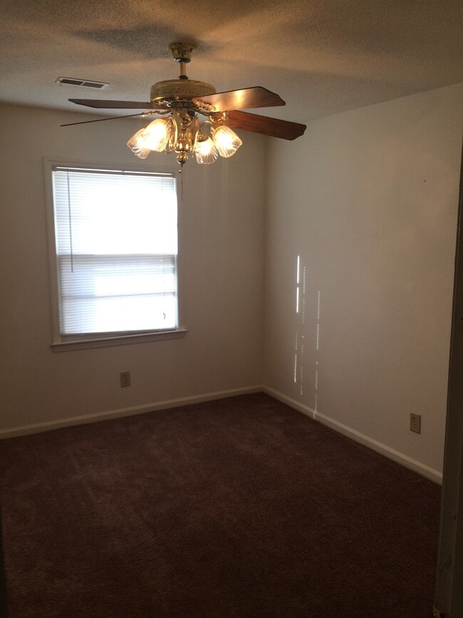 Building Photo - Brick Home with Carport & Fenced yard