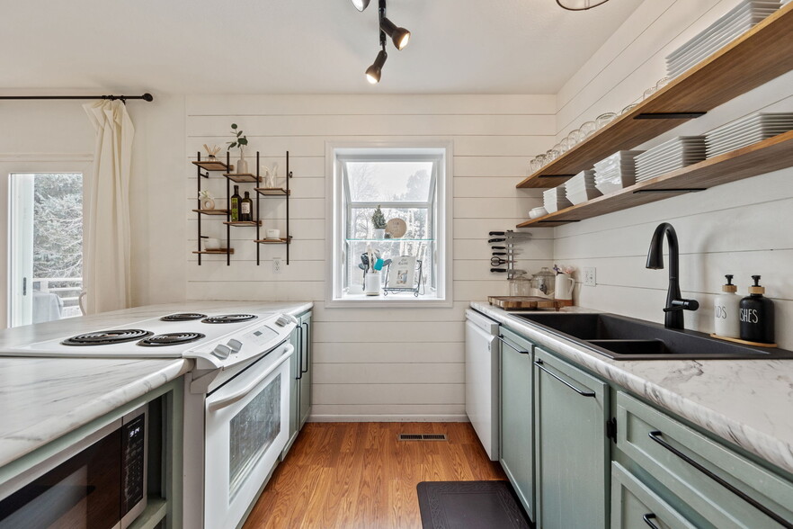 Bright kitchen area with a view of the backyard. - 3418 Stratton Dr