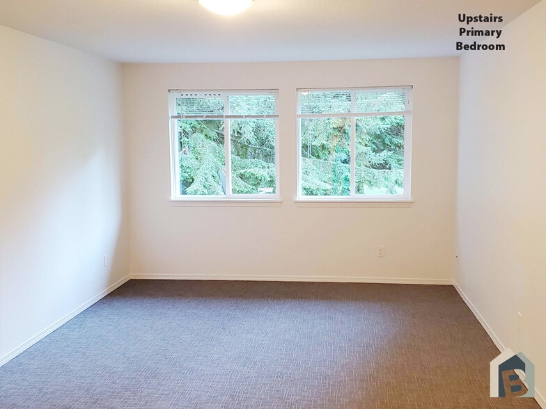 2nd floor large primary bedroom with beautiful view of mature evergreens - 20981 Port Gamble Rd NE