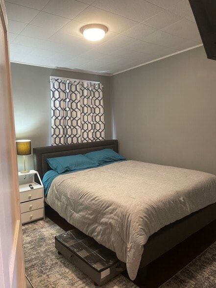 Smaller Bedroom with closet on left of nightstand - 20 Crescent St