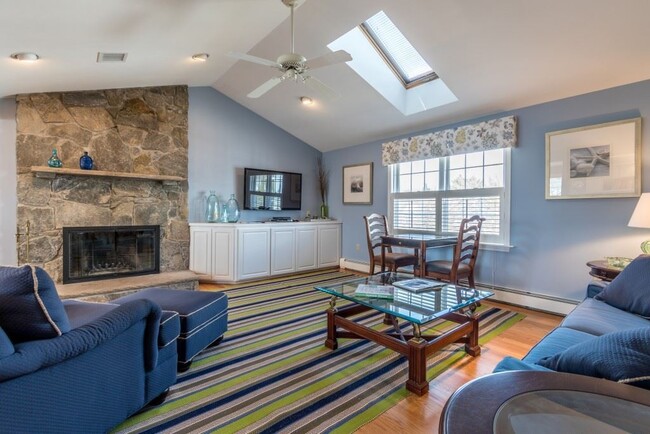 Vaulted living room ceilings with skylights and a wood-burning fireplace - 10 Myrica Ave