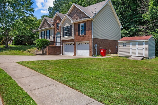 Building Photo - Stunning Stone Fireplace • Finished Basement • Fenced Yard
