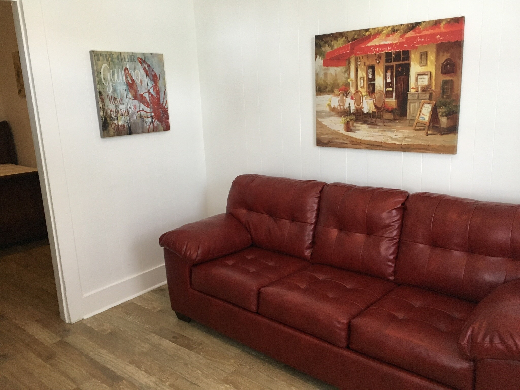 Living room with comfy red couch - 7602 Burthe St