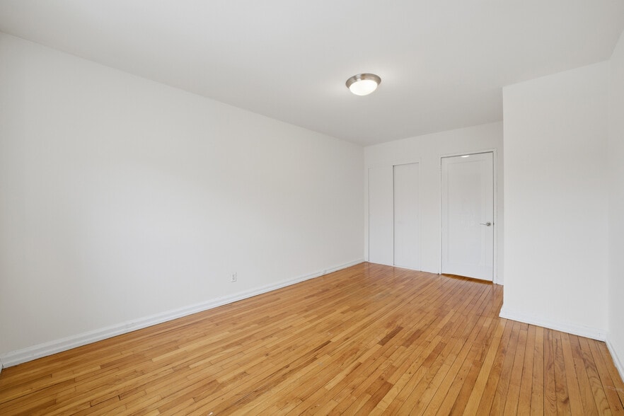 Bedroom featuring hardwood floors. - 555 Broadway