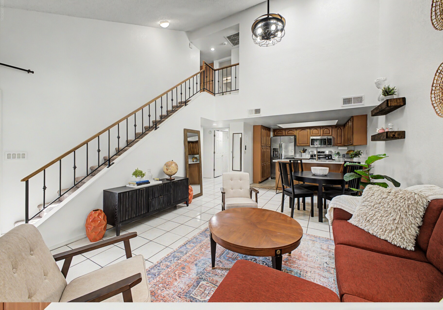 Vaulted ceilings and an open floor plan keep the main living area bright and airy - 819 N College Ave