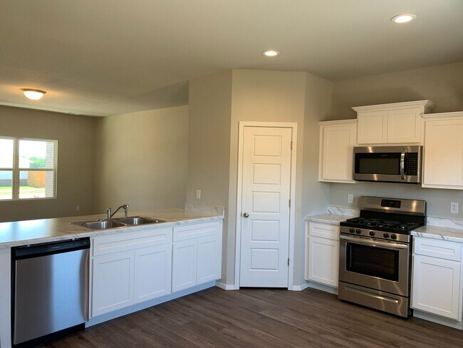 Building Photo - This well-designed 4-bedroom home has a split floor plan that gives the feeling of space.