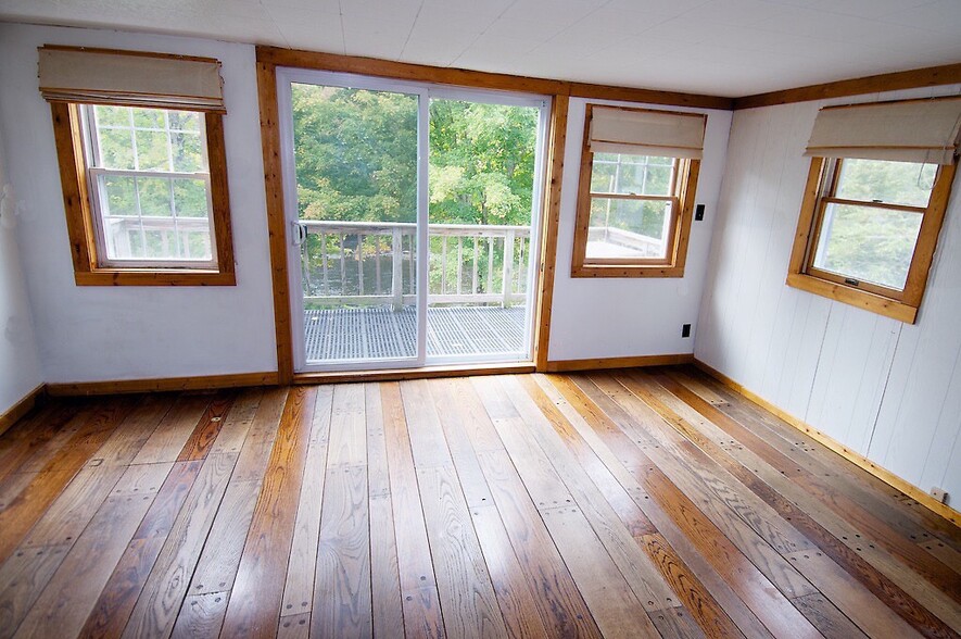 Living room with balcony overlooking river - 6201 NY-42