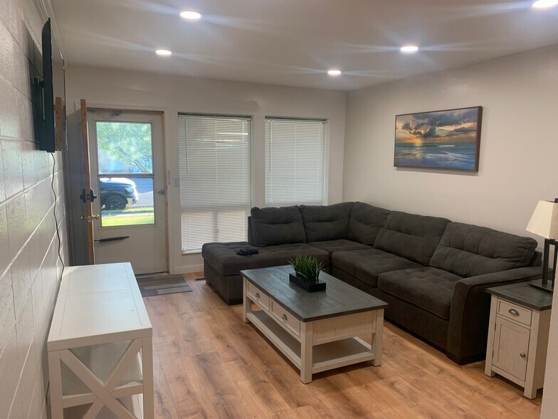 Living room with couch/television, coffee table, in table, condole - 886 Raymond Dr