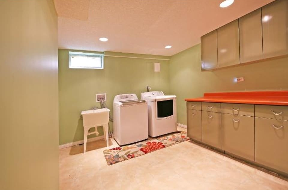 Bright, cheerful laundry room with washer, dryer, and folding counter - 5813 Tracy Avenue