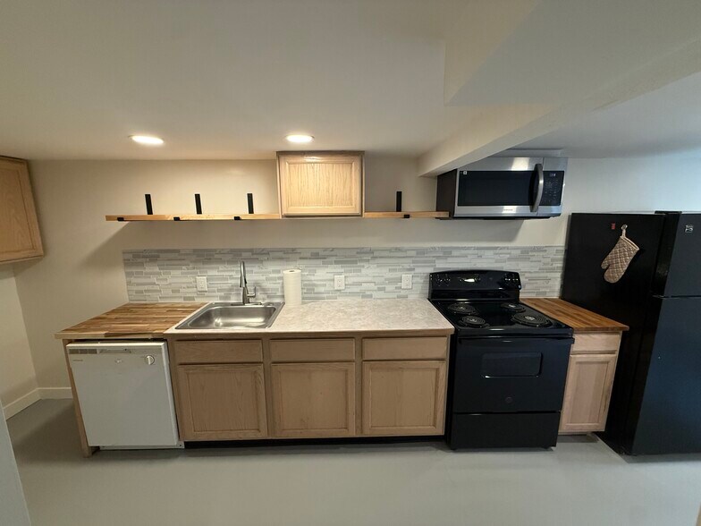 Full Kitchen w/ accent wood counters and open shelving - 5454 45th Ave SW