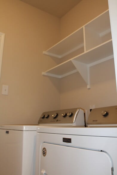 Home equipped with full-size washer and dryer. Additional Shelving in laundry room - 1027 Aurora Grove Bnd