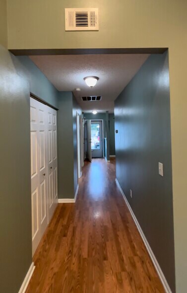 main hallway looking to front door. Washer/Dryer in utility closet to left - 1208 Apex Ln
