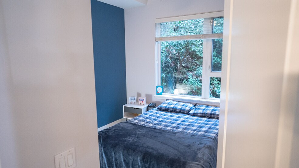 Medium sized bedroom with blue accent wall. - 375 Kirkland Ave