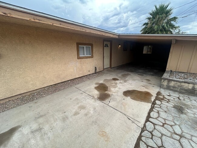 Building Photo - Single story home with large backyard and huge carport with plenty of storage.