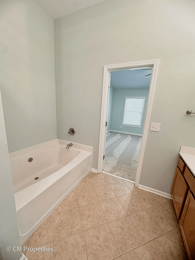 Main Bathroom with soaking tub and upgraded fixtures. - 3968 Boston Common St