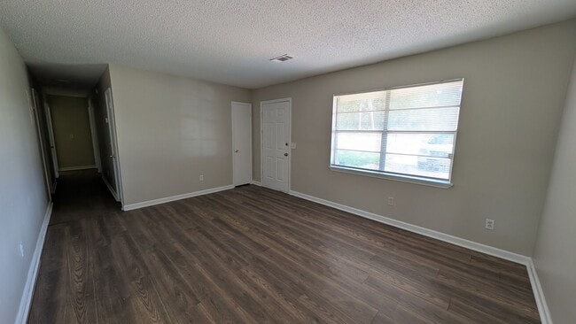 Building Photo - Fenced Yard, Lots of Light, Hard Floors Throughout