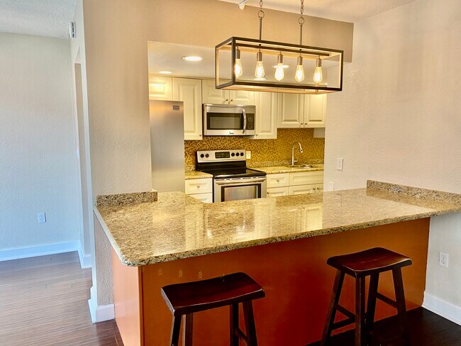 Large granite counter space serves as gathering and work table - 470 3rd St S