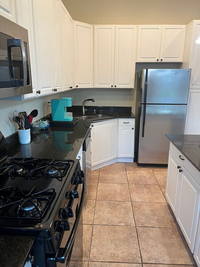 Kitchen with full stove; microwave, dishwasher, air fryer, and Keurig - 2219 Missouri Ave